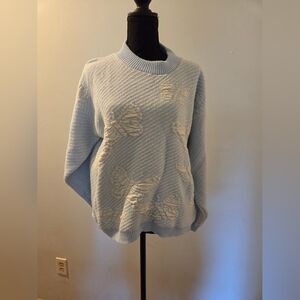 Elegant Sky Blue Sweater with Floral Accents